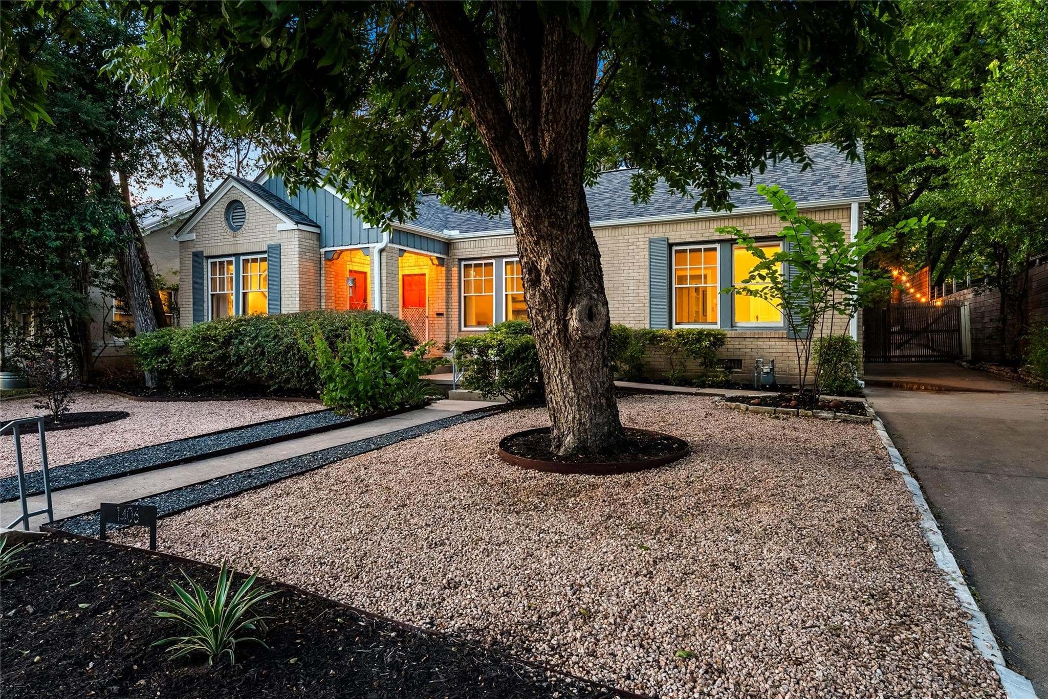 A charming brick residence awaits, featuring a gr