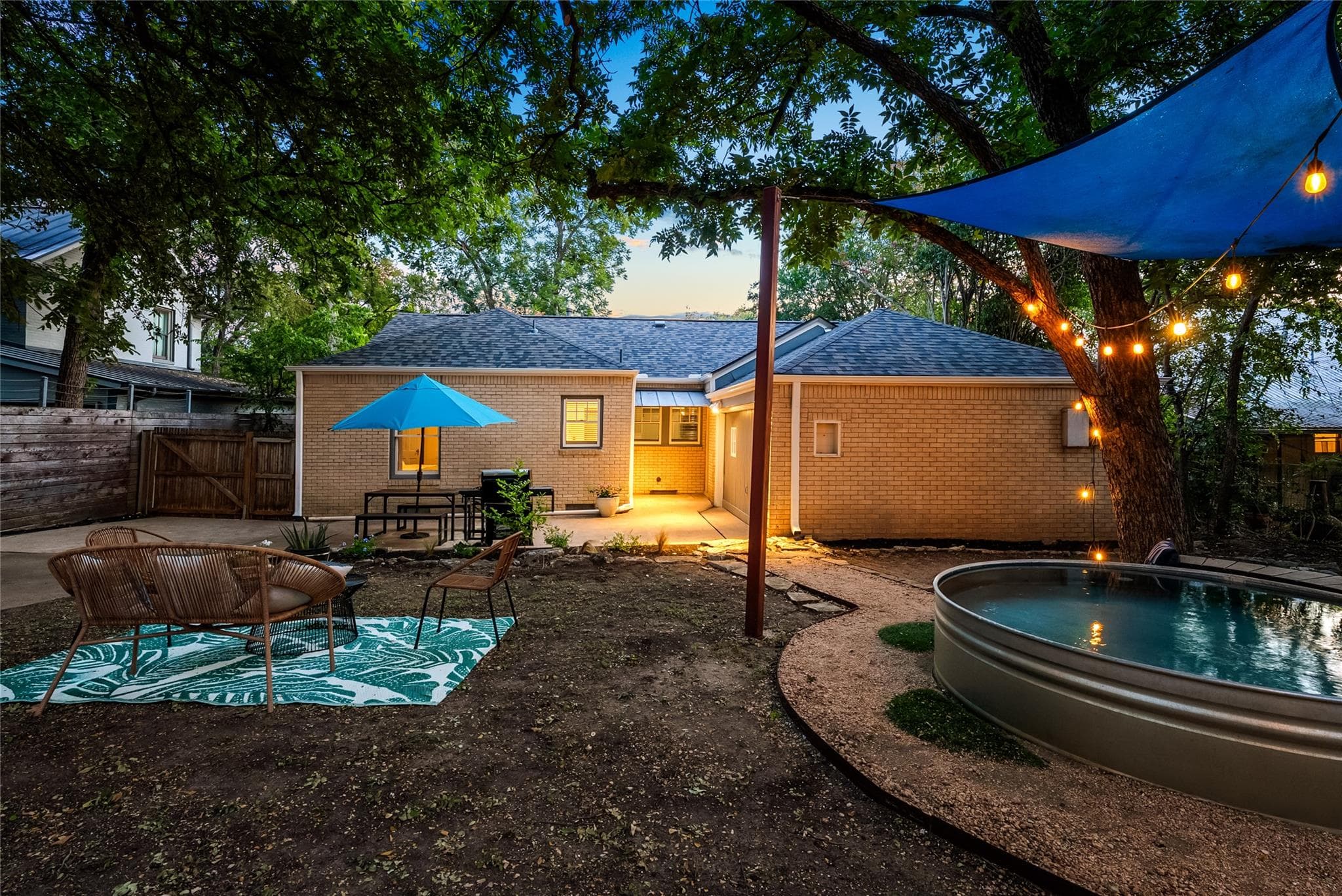 A private yard with a cozy patio and string light