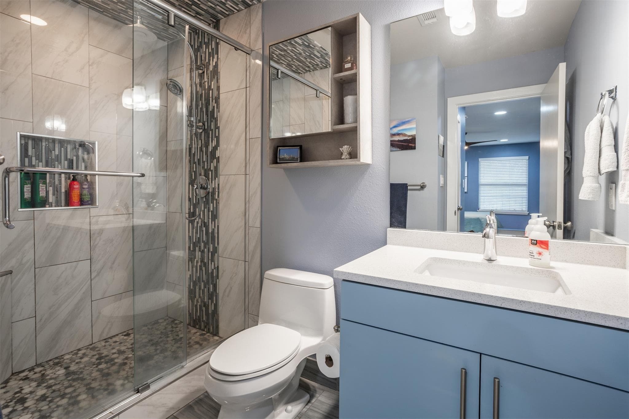 Bathroom with vanity, a stall shower, and connect