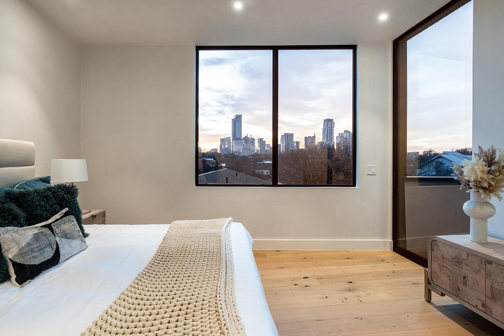 Floor-to-ceiling windows frame a dynamic cityscap