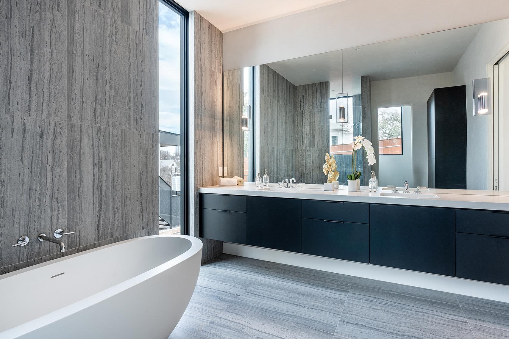 A spacious primary bathroom boasts a freestanding