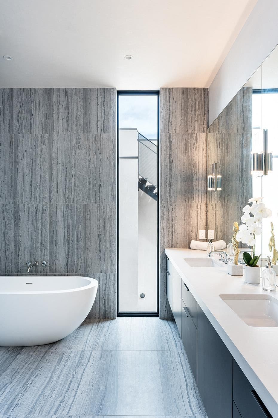 A freestanding soaking tub complements the double