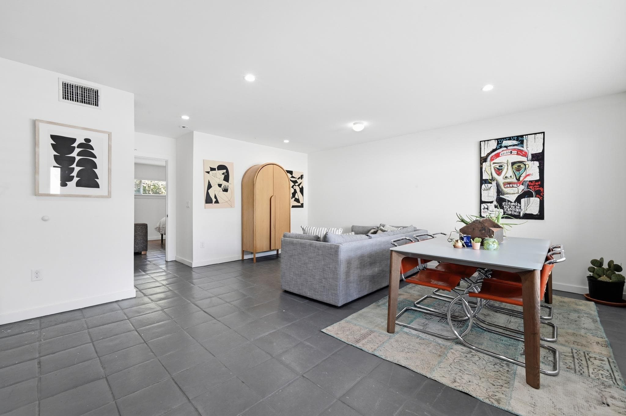 Recessed lighting illuminates this versatile livi