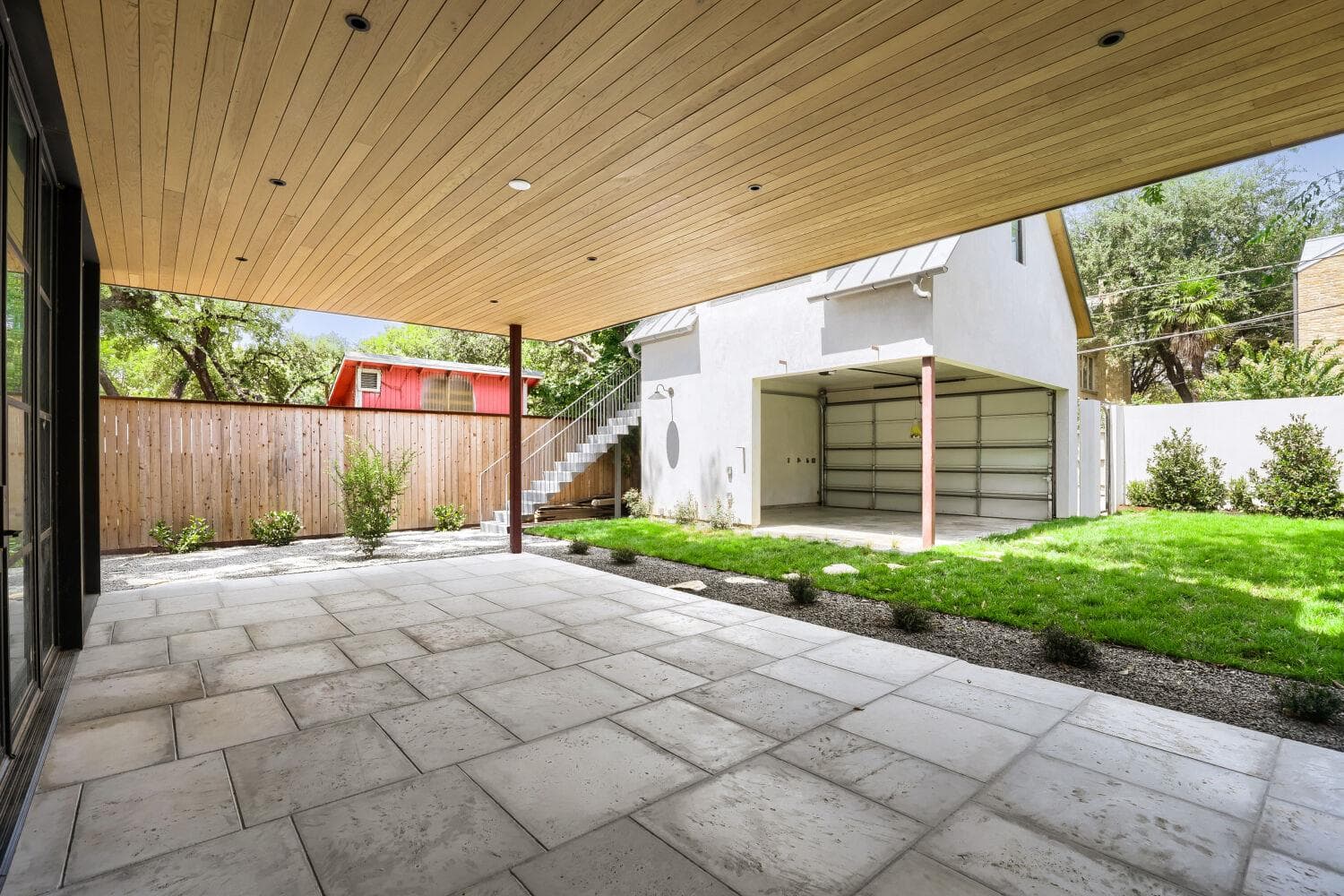 An inviting covered patio with a paved surface ex