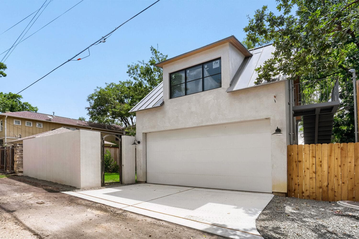 A modern garage with an upper-level dormer provid