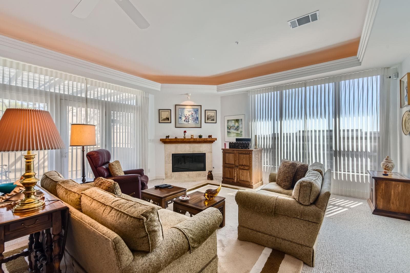 Living area featuring visible vents, ceiling fan,