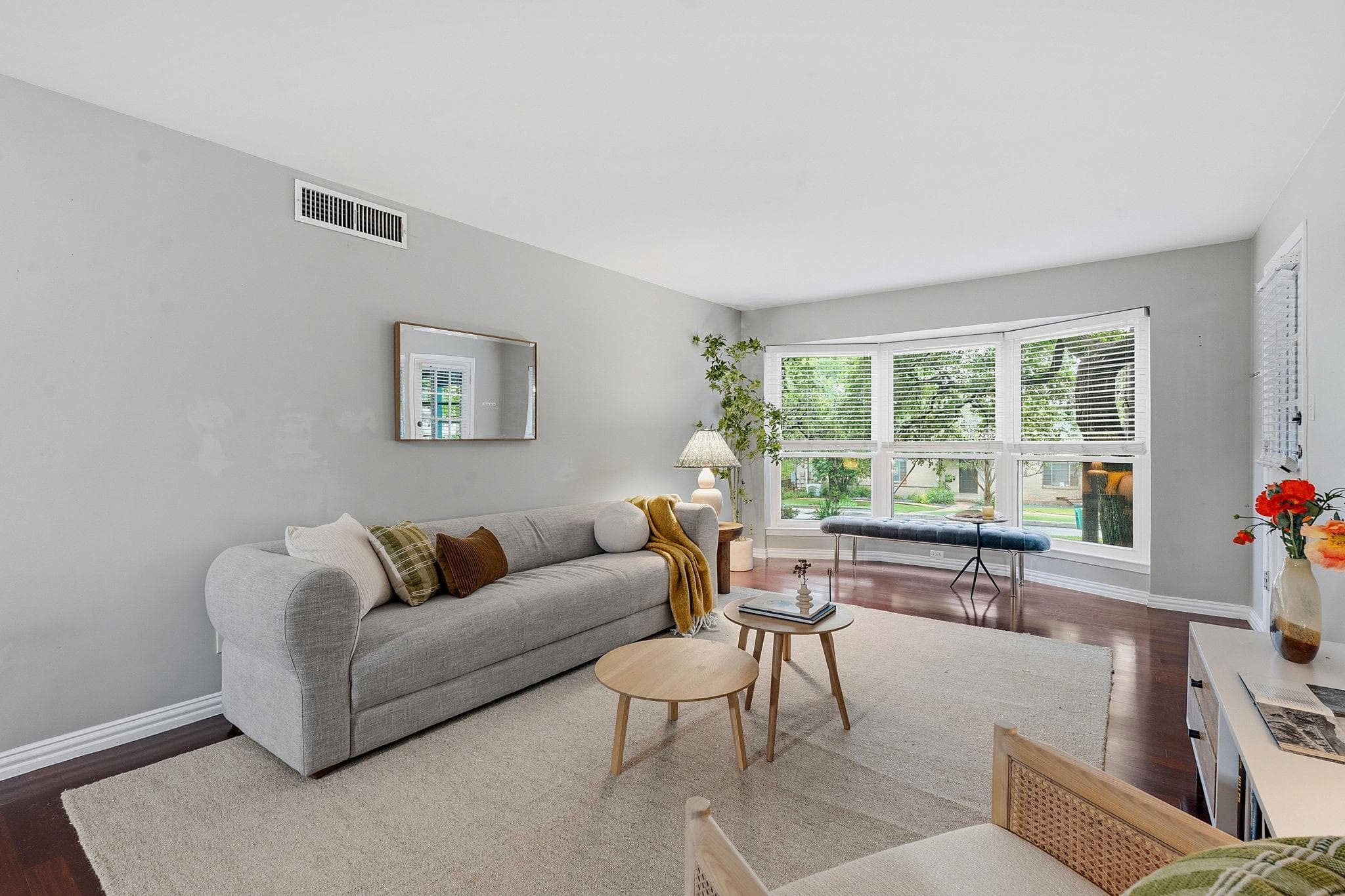 A well-lit living space features rich hardwood fl