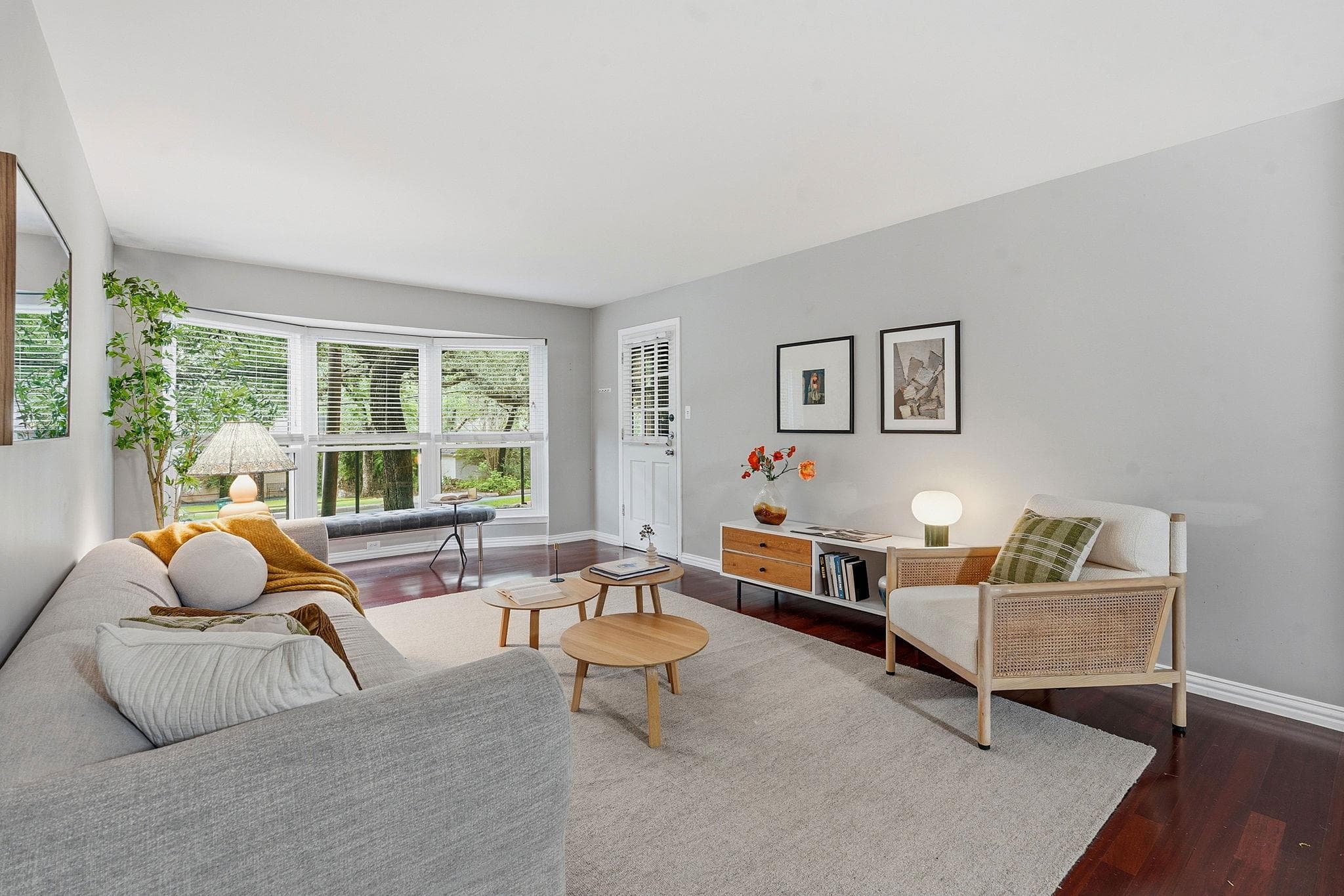 Hardwood floors and a wide bay window define this