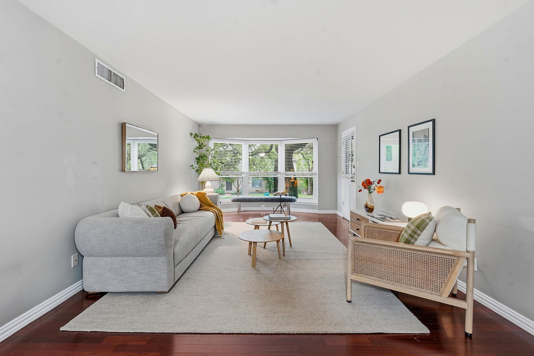 Hardwood floors and a wide bay window define this