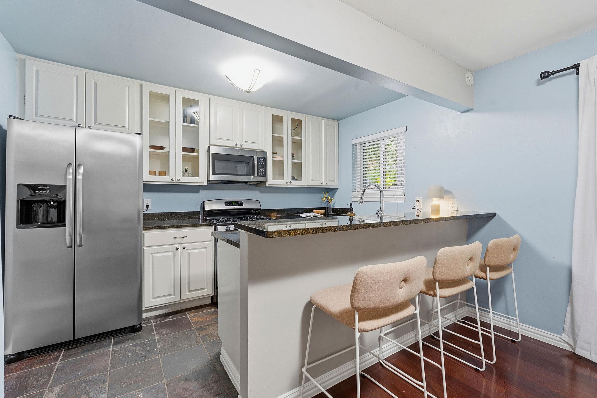 A well-appointed kitchen features a practical bre