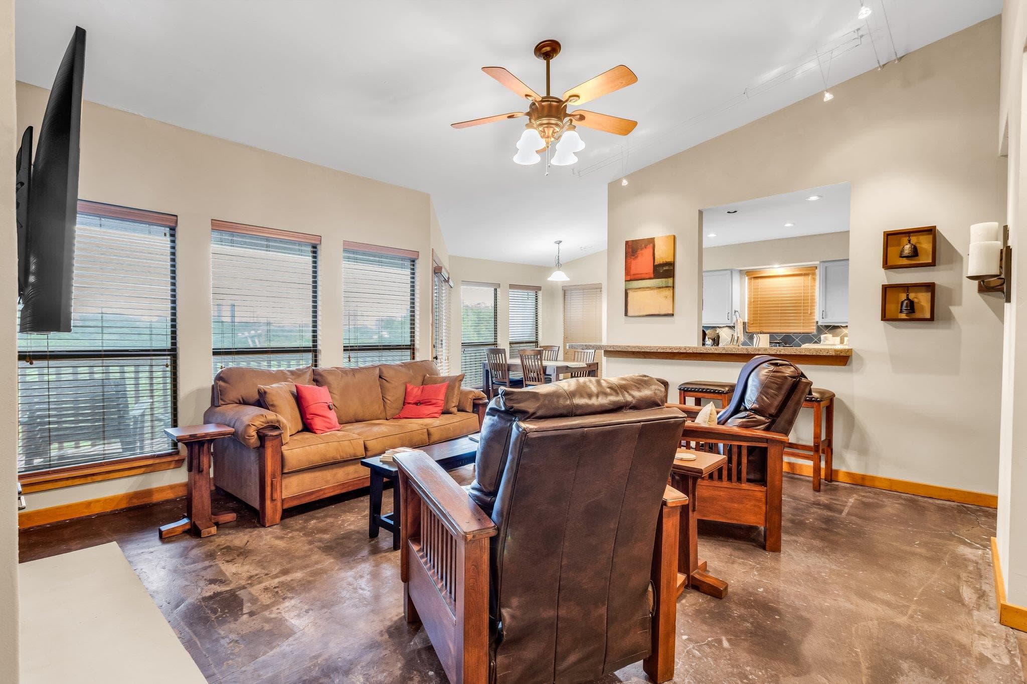 Living room with rail lighting, ceiling fan, base
