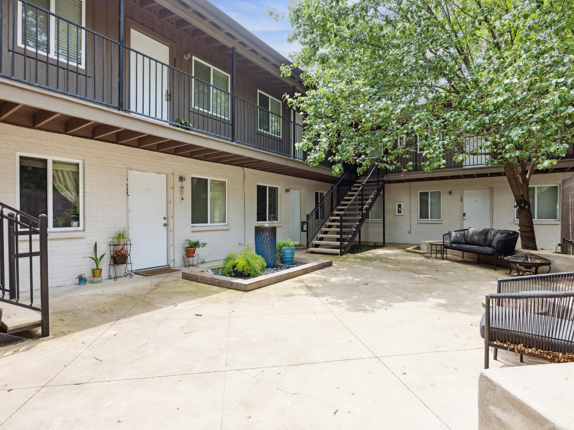 Central courtyard with concrete paving, mature tr