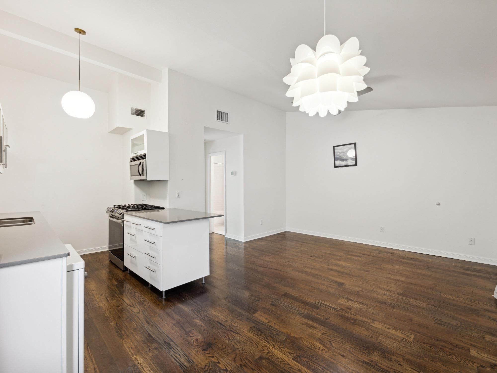Open-concept living space featuring wood-finish f