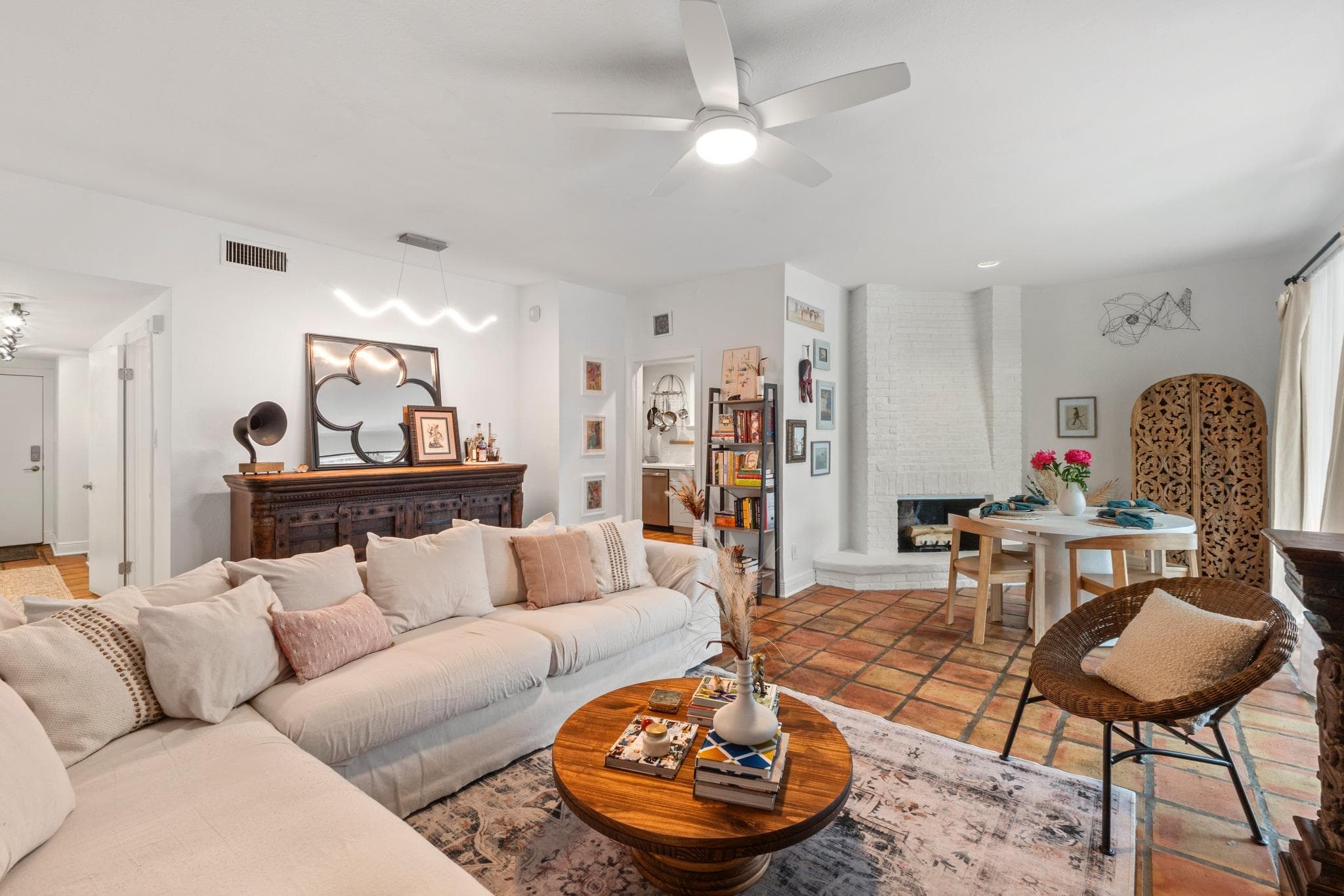 Living area featuring terracotta tile flooring, a