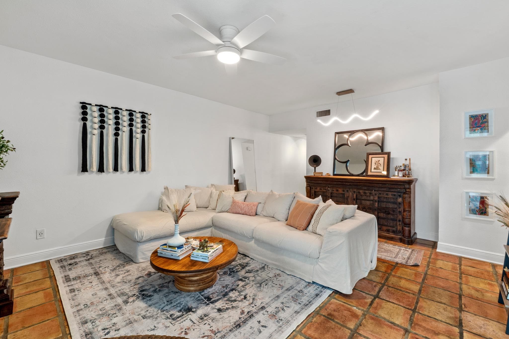 Spacious living area featuring terra cotta tile f