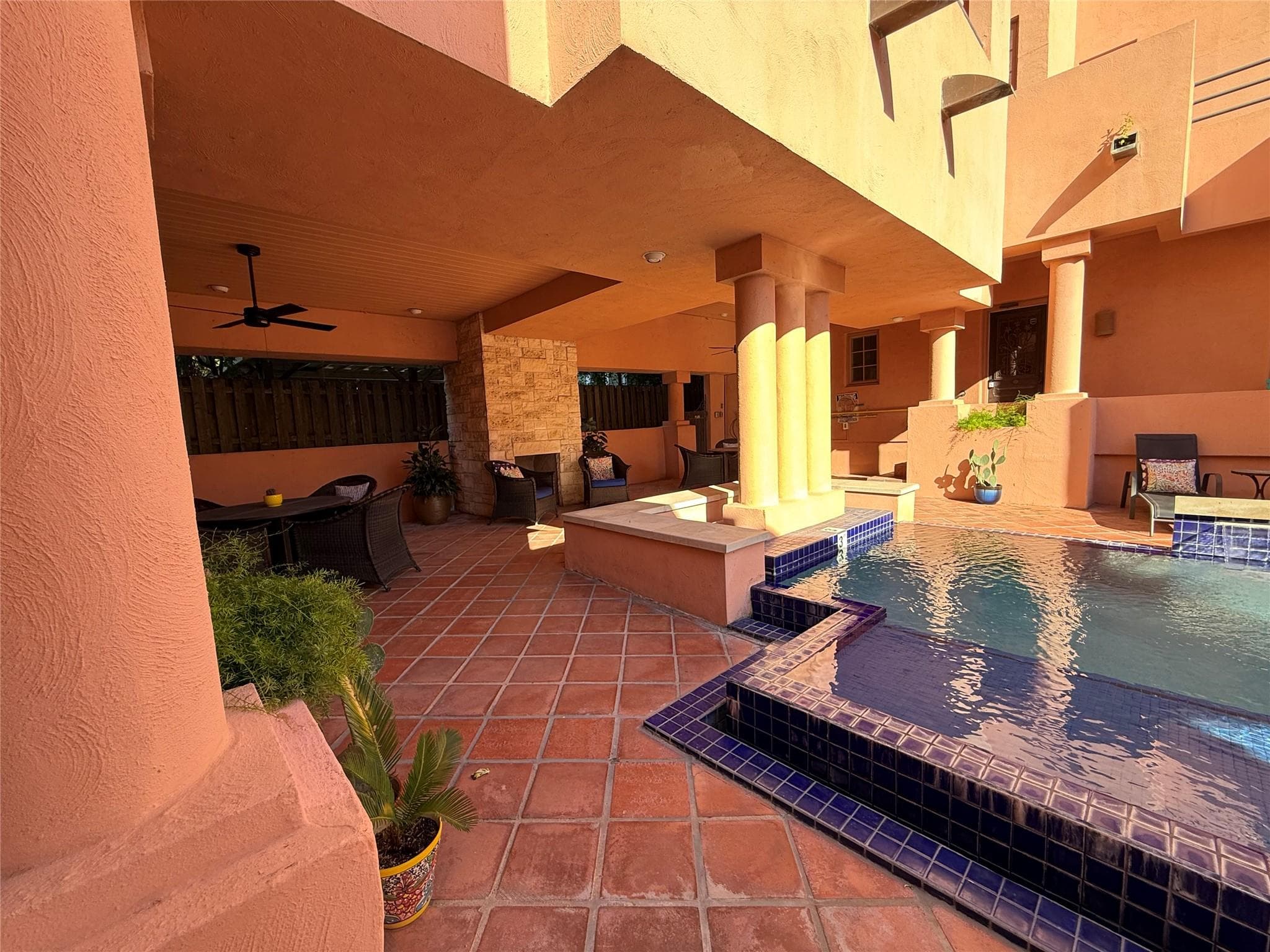 View of patio with an outdoor pool and ceiling fan