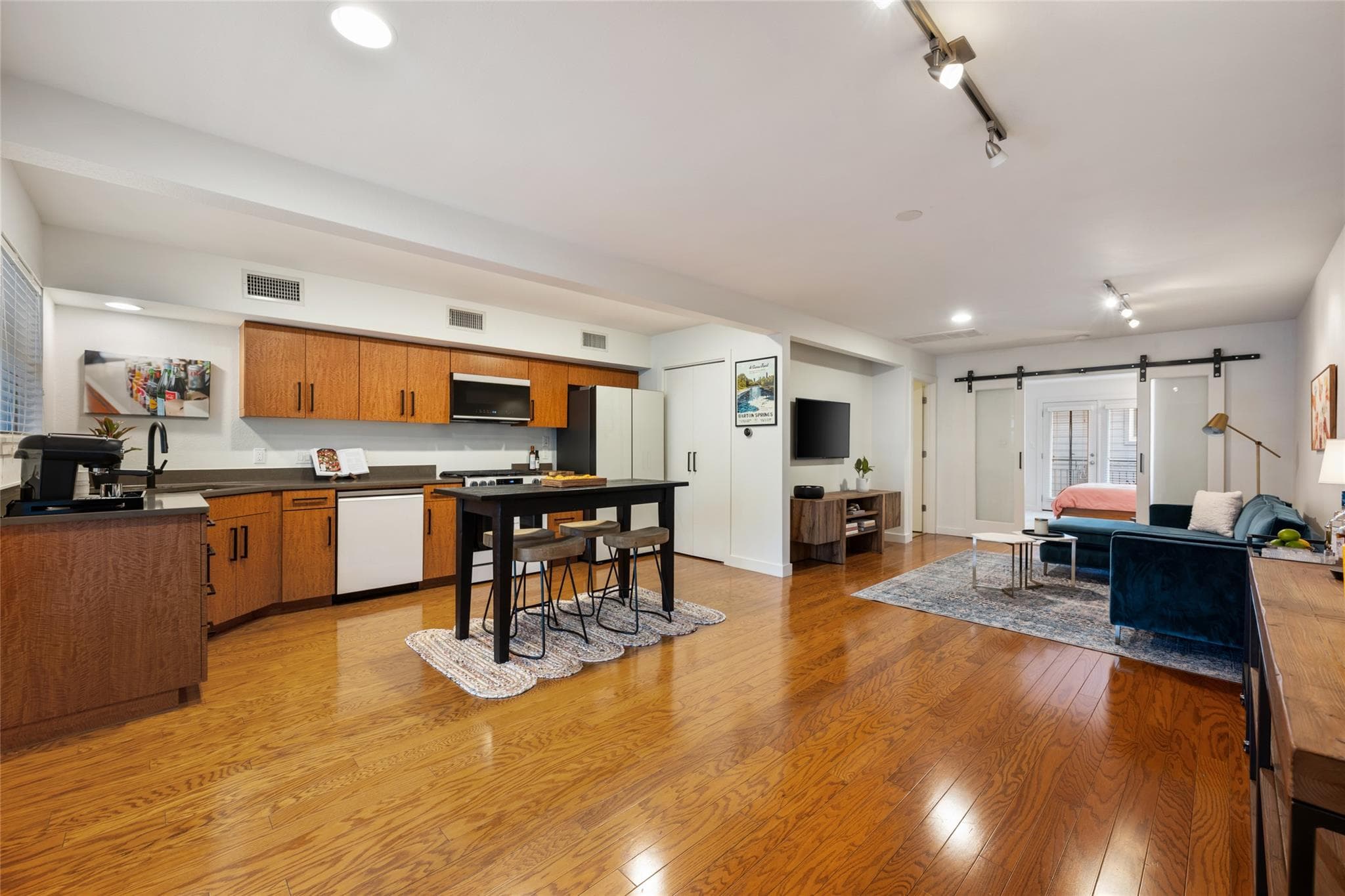 Gleaming hardwood floors run throughout this vers