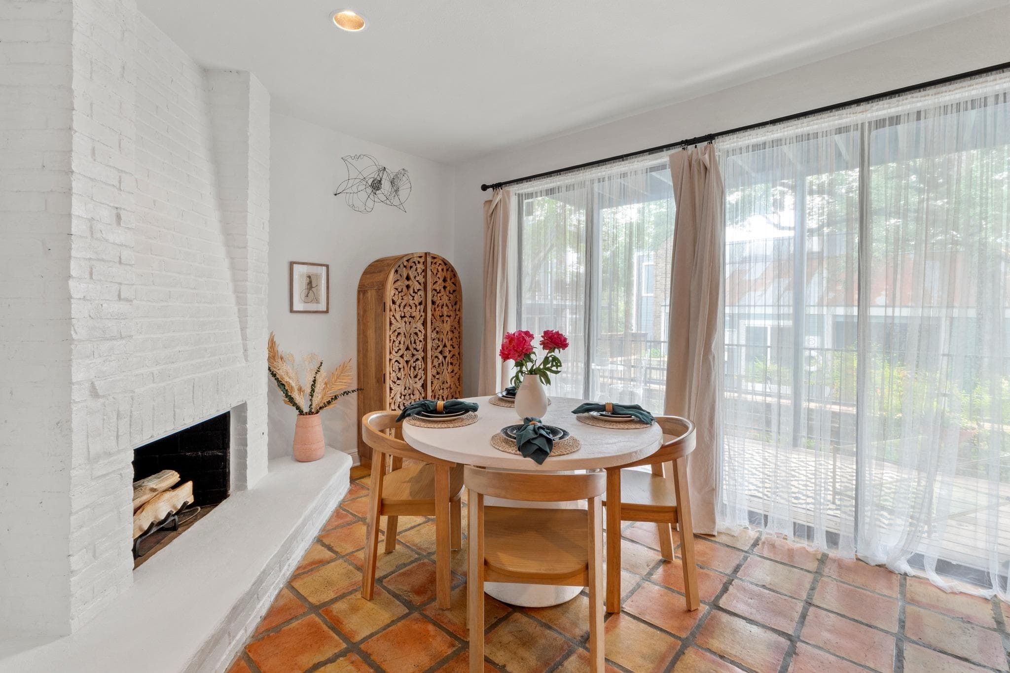 Saltillo tile flooring, a painted brick fireplace